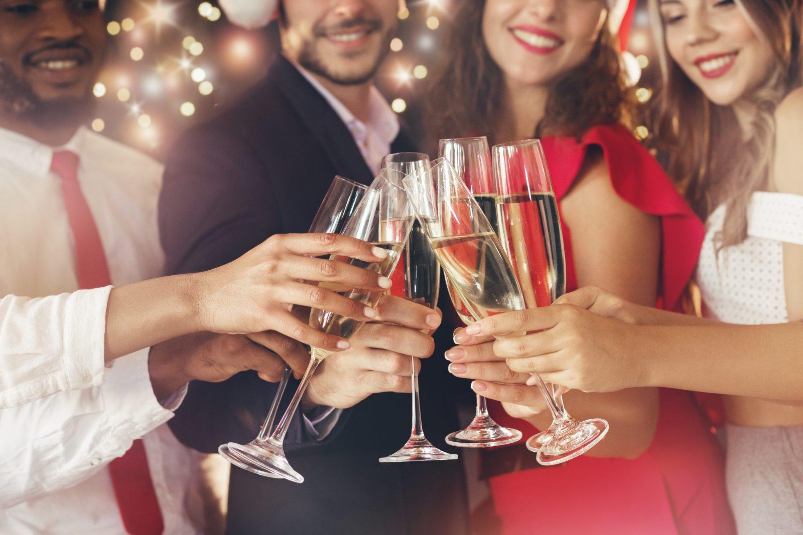 Champagne glasses in people hands at New Year
