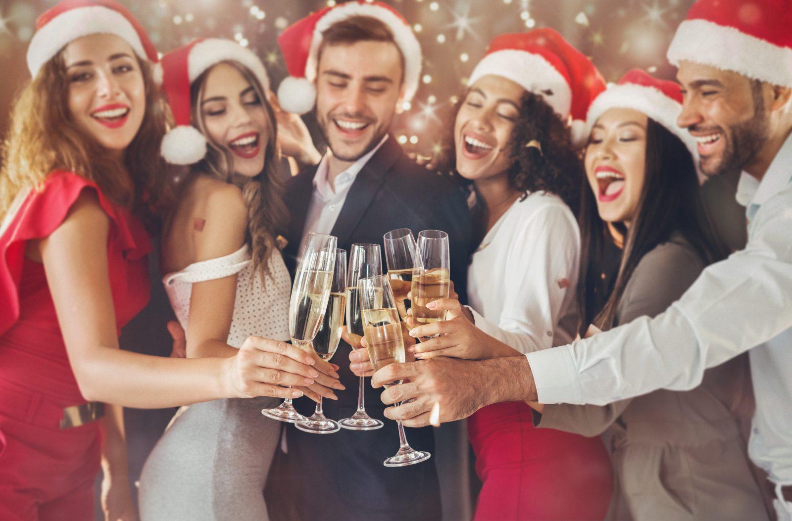 Diverse friends clinking with champagne glasses on New Year's Eve